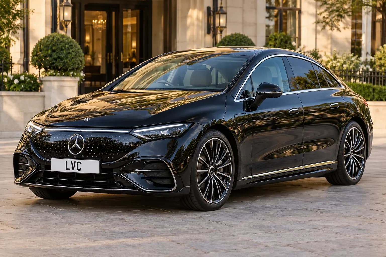 Black electric Mercedes-Benz chauffeur car outside a luxury hotel