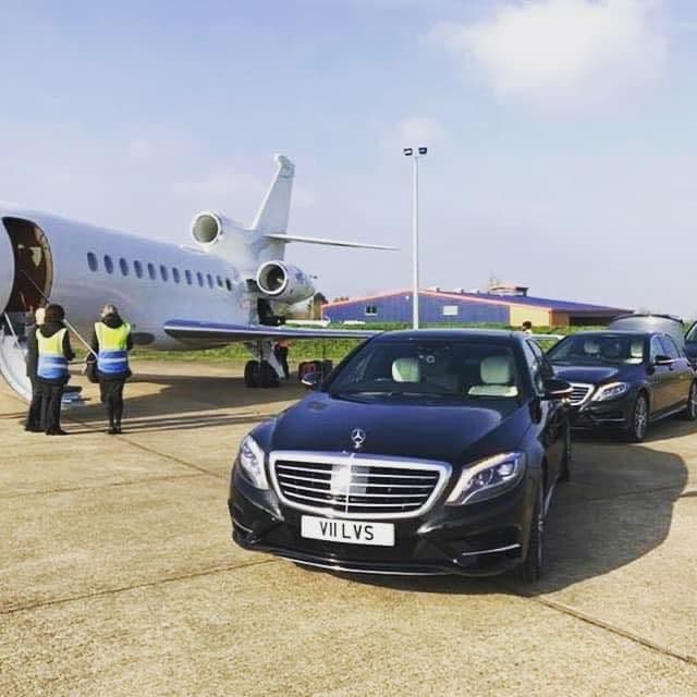 Mercedes S-Class parked near a private jet at the FBO terminal, ready for VIP transfer.