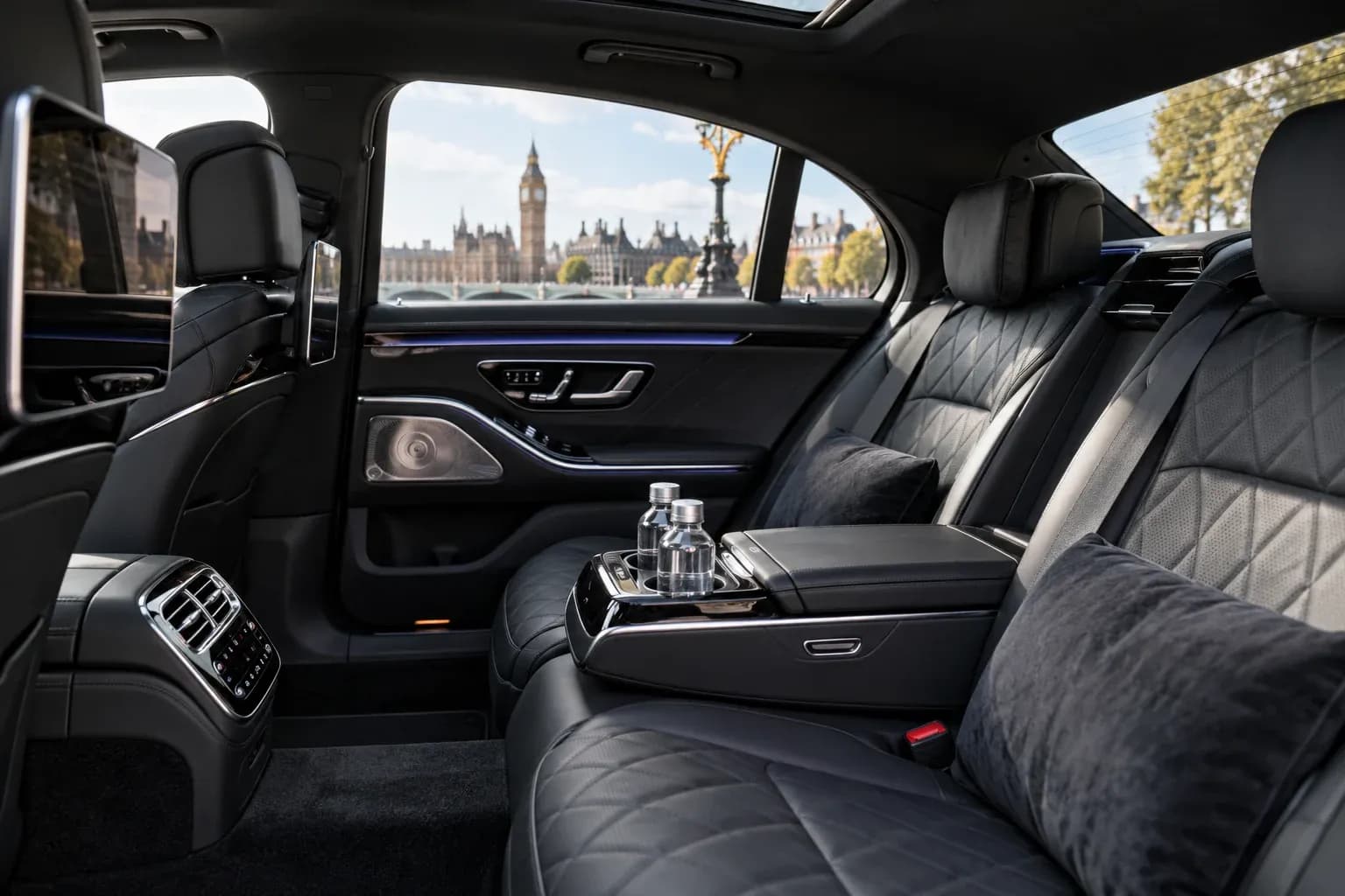 Leather rear passenger seats and bottled water inside a Mercedes-Benz S-Class