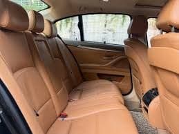 Spacious rear passenger seating in the BMW 5 Series executive chauffeur vehicle.