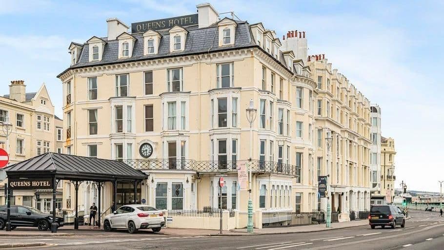 Executive chauffeur service outside a luxury seaside hotel in Brighton.