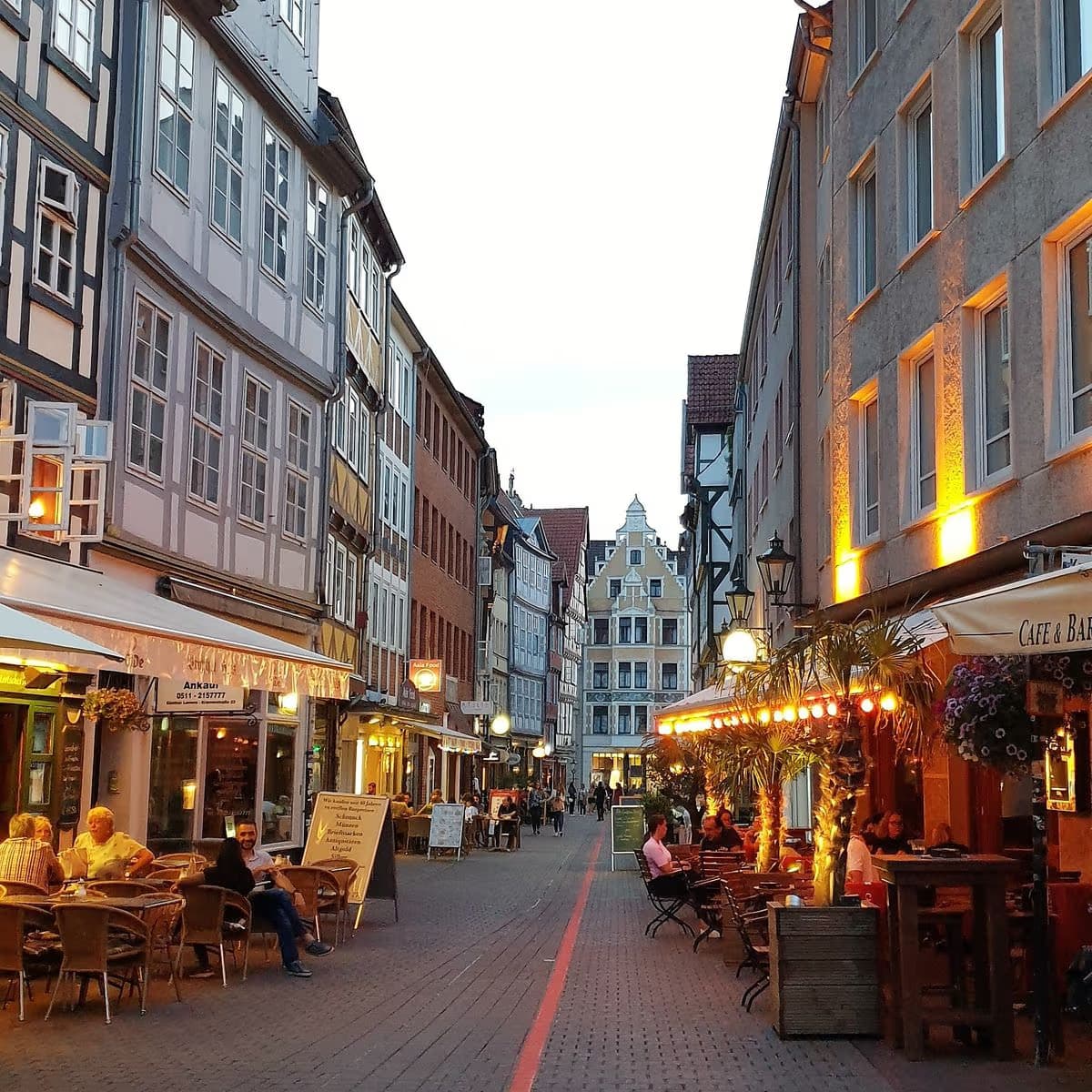 Luxury chauffeur service on a Brighton street with restaurants for city-to-city transfers.