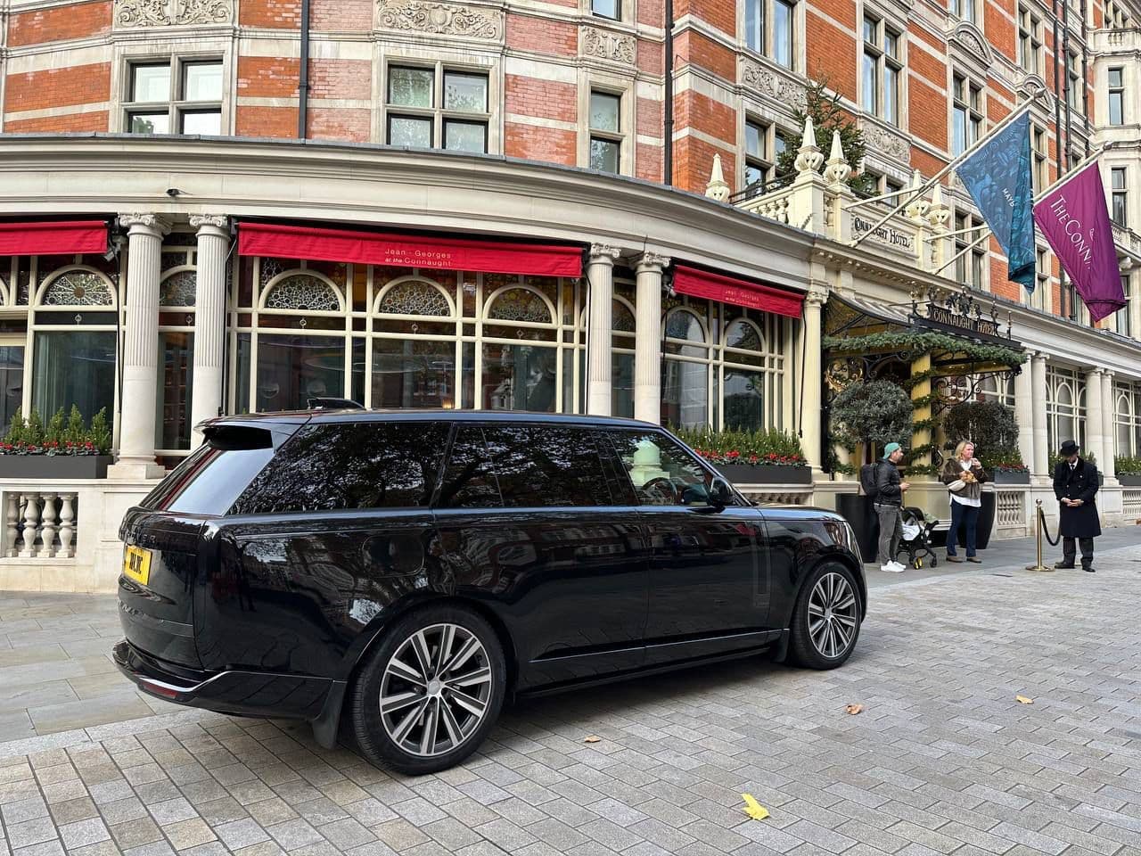 Luxury SUV chauffeur parked in front of a hotel in London, ready for hourly hire for corporate or private clients.