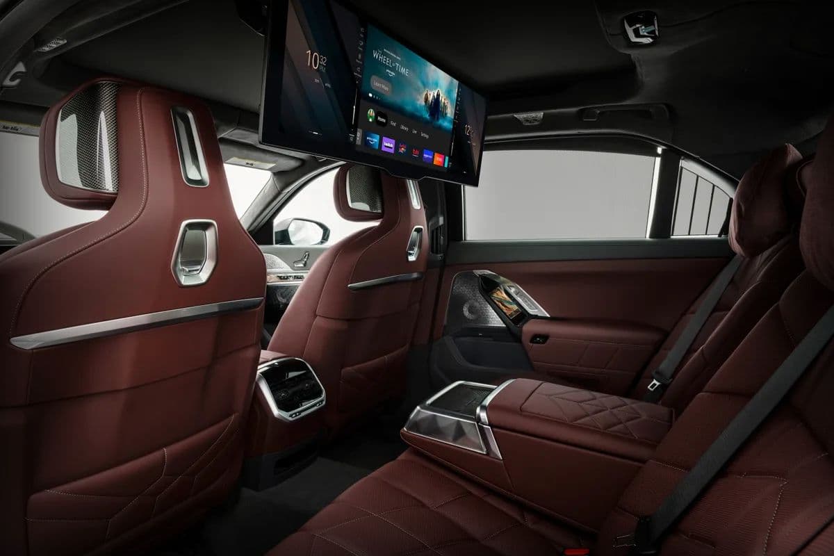 Luxury BMW 7 Series chauffeur rear seat with entertainment screen in executive vehicle in London