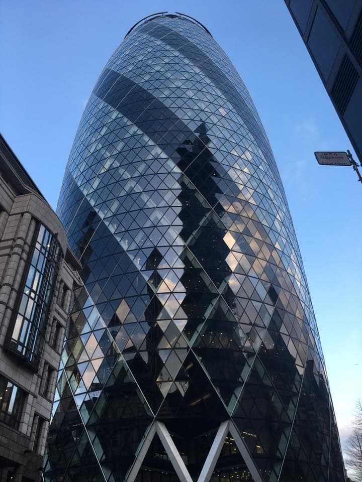 Luxury chauffeur-driven Mercedes-Benz parked outside The Gherkin in the City of London