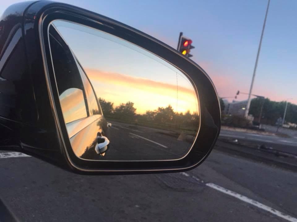 Luxury Mercedes driving on the motorway with driver visible in rear-view mirror, heading to Henley-on-Thames event