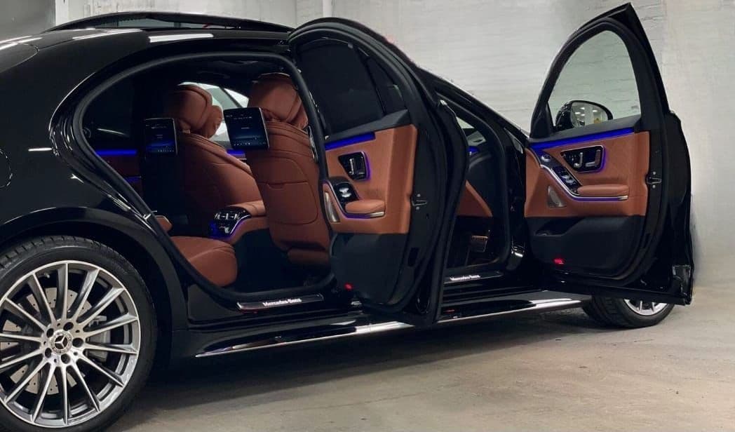 Mercedes-Benz S-Class luxury interior for VIP concert and chauffeur events, featuring premium leather seats, ambient lighting, and spacious comfort for passengers.