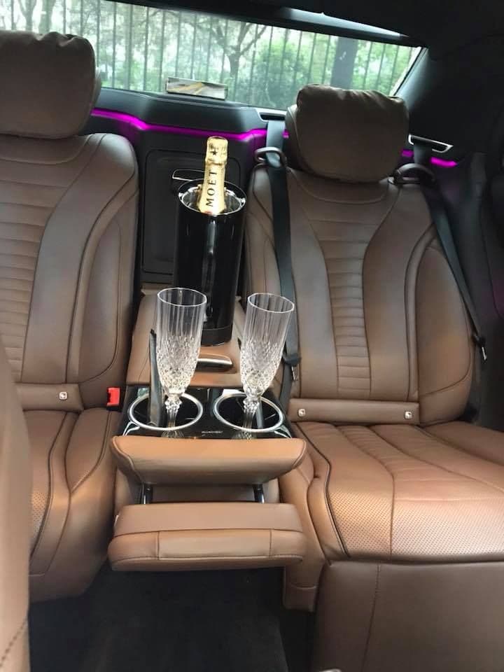 Interior of a Mercedes-Benz S-Class with a bottle of champagne and glasses for luxury clients in London