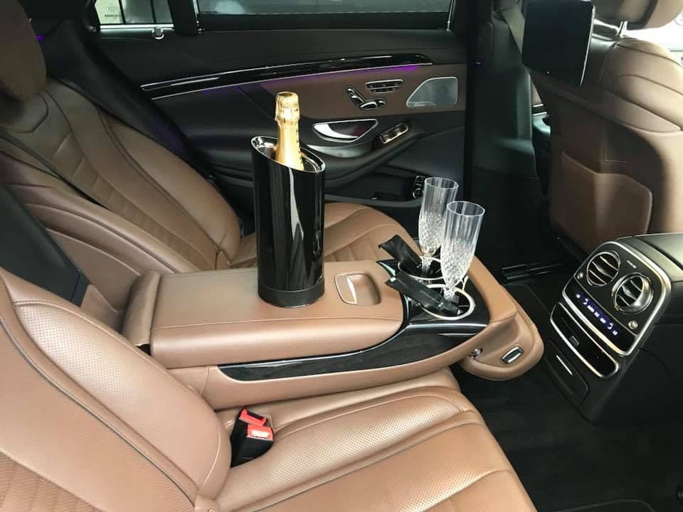 Mercedes-Benz S-Class interior with champagne and glasses prepared for VIP chauffeur client