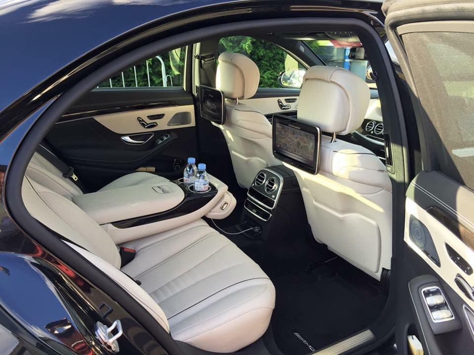 Luxury interior of a Mercedes S-Class in London, featuring plush leather seats and ambient lighting, ready for a VIP transfer to a Wembley concert.