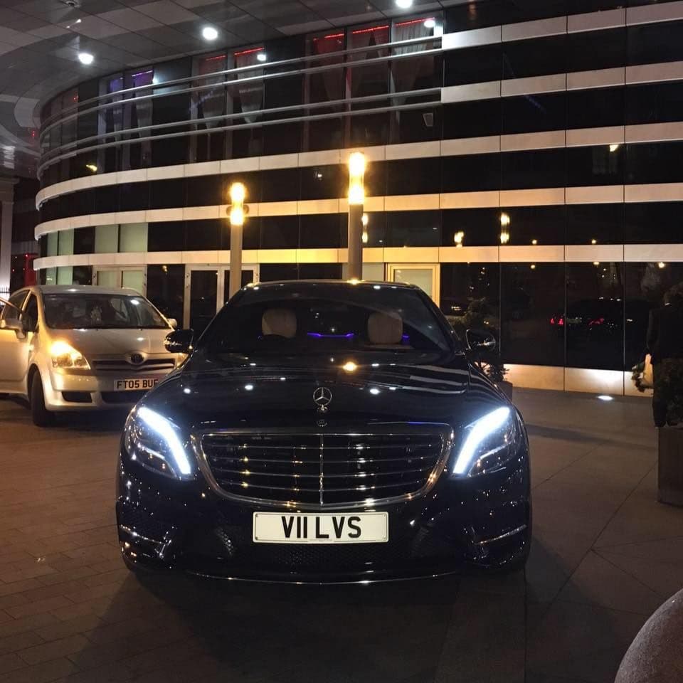 Private chauffeur waiting outside a Mayfair hotel to transfer a VIP client to and from Harrods Aviation