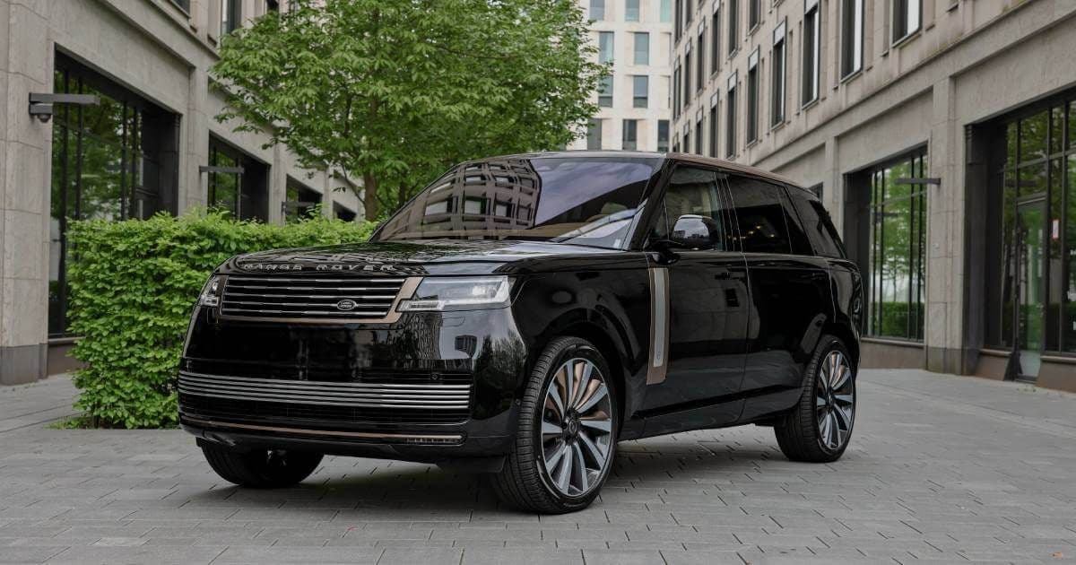 Range Rover Autobiography parked near Mayfair hotel with chauffeur waiting for VIP clients in London