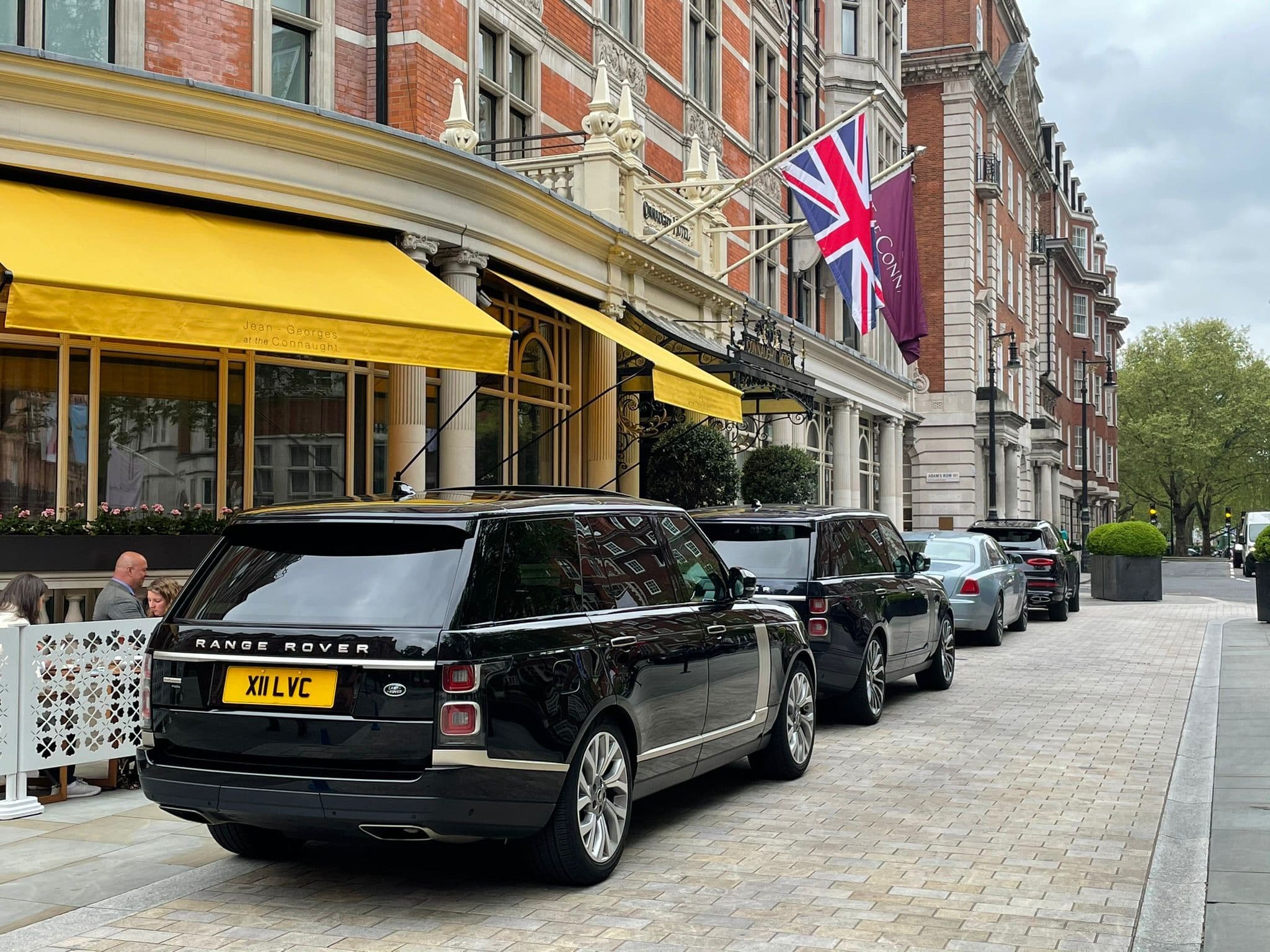 Fleet of Range Rover cars waiting in front of a hotel for Stansted Airport transfer