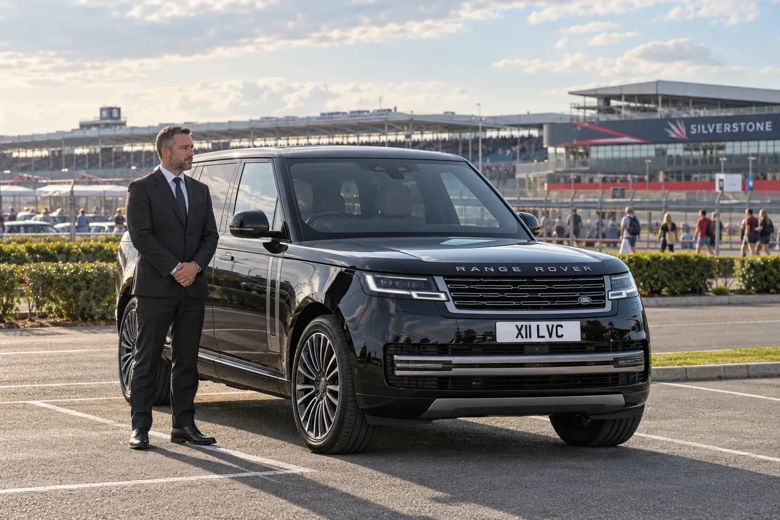 Chauffeur waiting beside a Range Rover for a Silverstone return journey.